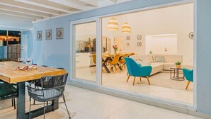 A modern interior with a dining area, a kitchen, and a living room.