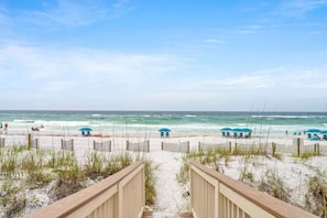 A beach pathway leading to the ocean with beach umbrellas and chairs. - Sea Destin - Private BeachFront Townhouse (Destin)