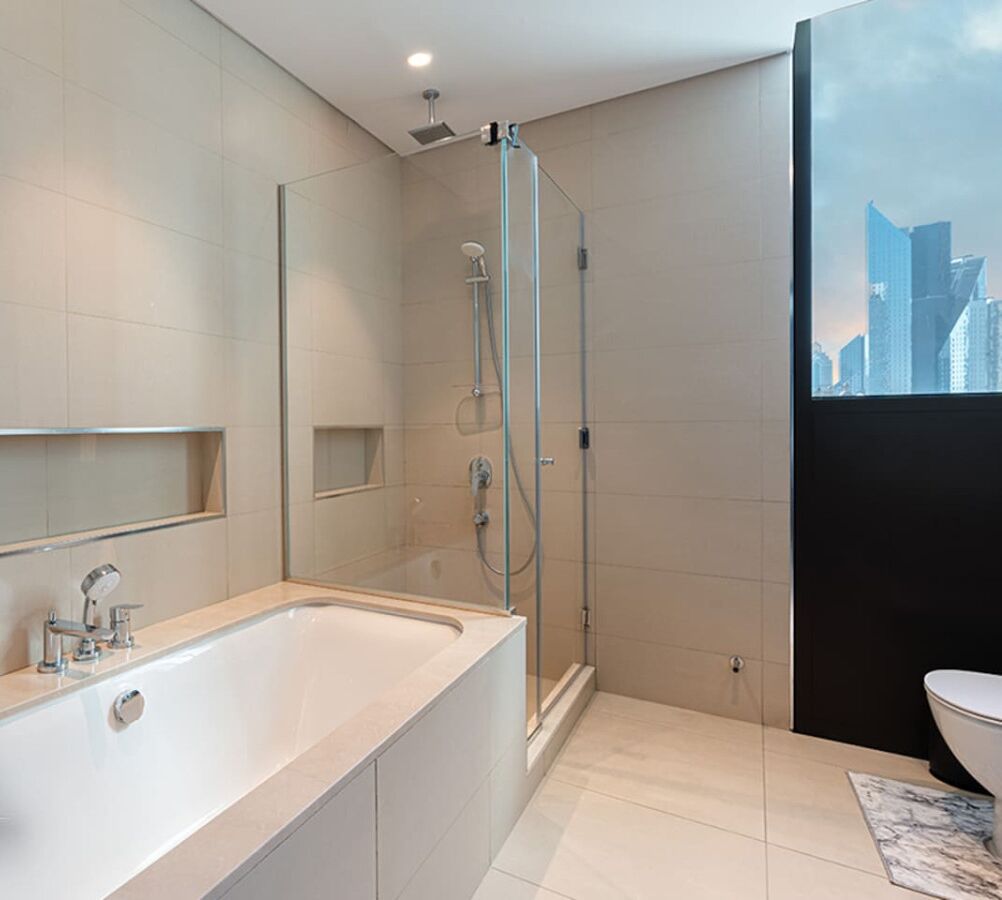Une salle de bain moderne avec une grande baignoire, une douche à l’italienne et des toilettes.