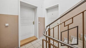 A staircase with a metal handrail and a wooden floor. - Gorgeous apartment in Anklam (Anklam)