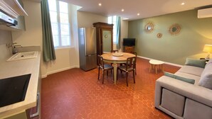 A compact living space with a kitchen, dining area, and seating area.