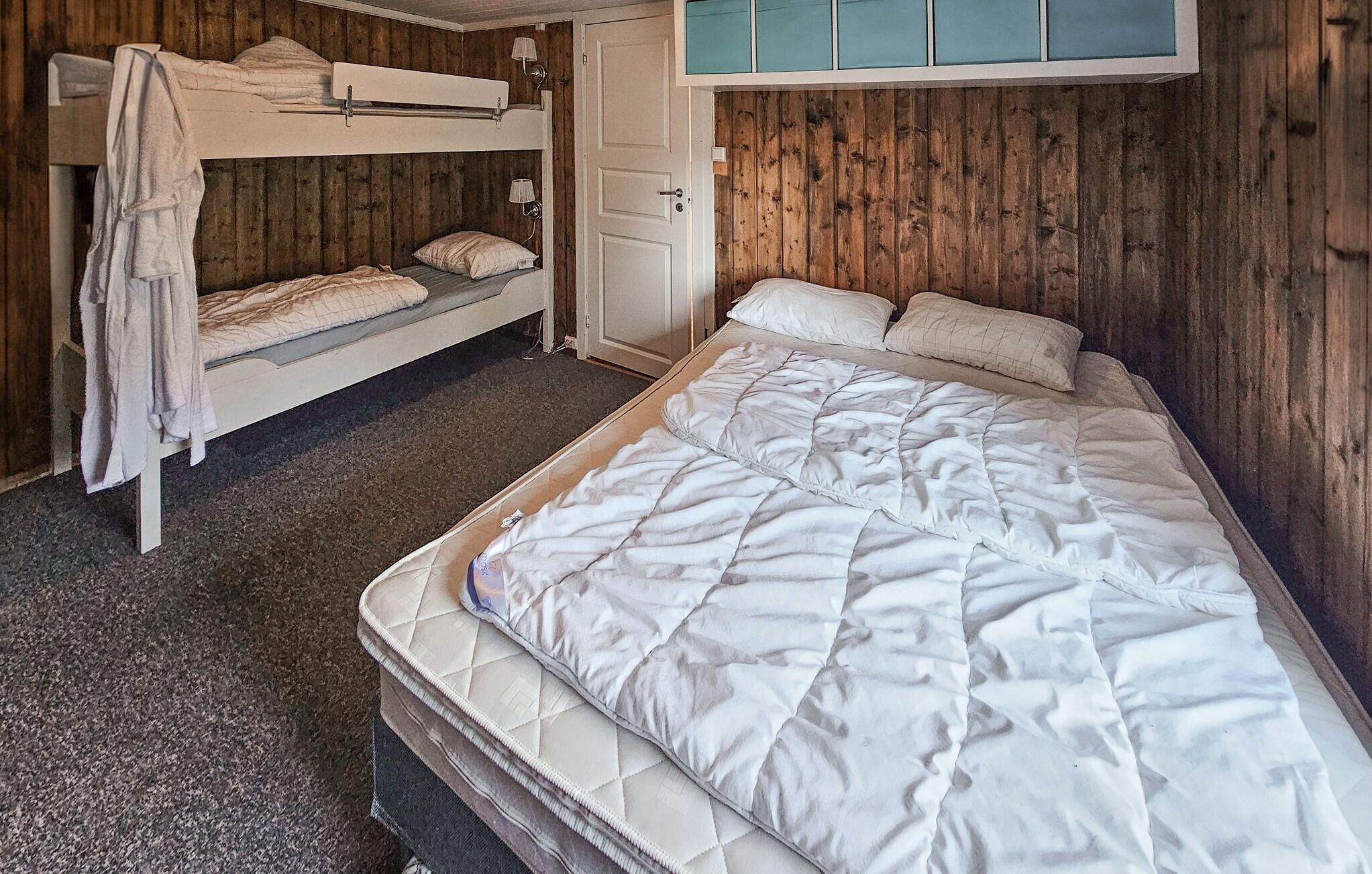 A bunk bed room with a single bed and two bunk beds.