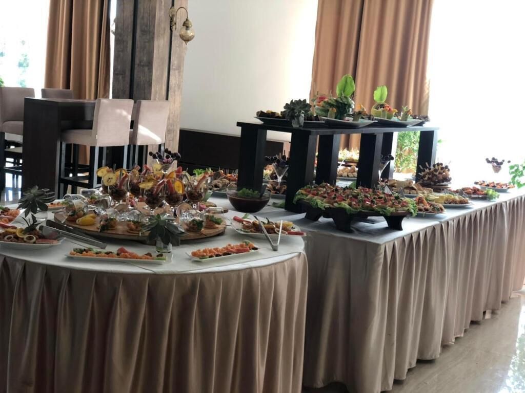 A buffet table with various food items and a decorative centerpiece.