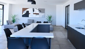 Enjoy cooking in this kitchen with a sleek island, sink, and pendant lighting.