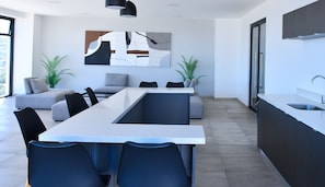 Enjoy cooking in this kitchen with a sleek island, sink, and pendant lighting.