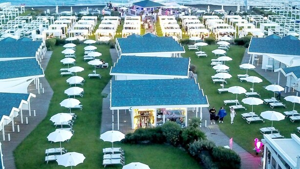 An aerial view of a coastal resort with rows of beachside villas, each with a private pool and umbrella seating. - Villetta Alessandra Ostia Antica 10 mins from beach (Lazio)