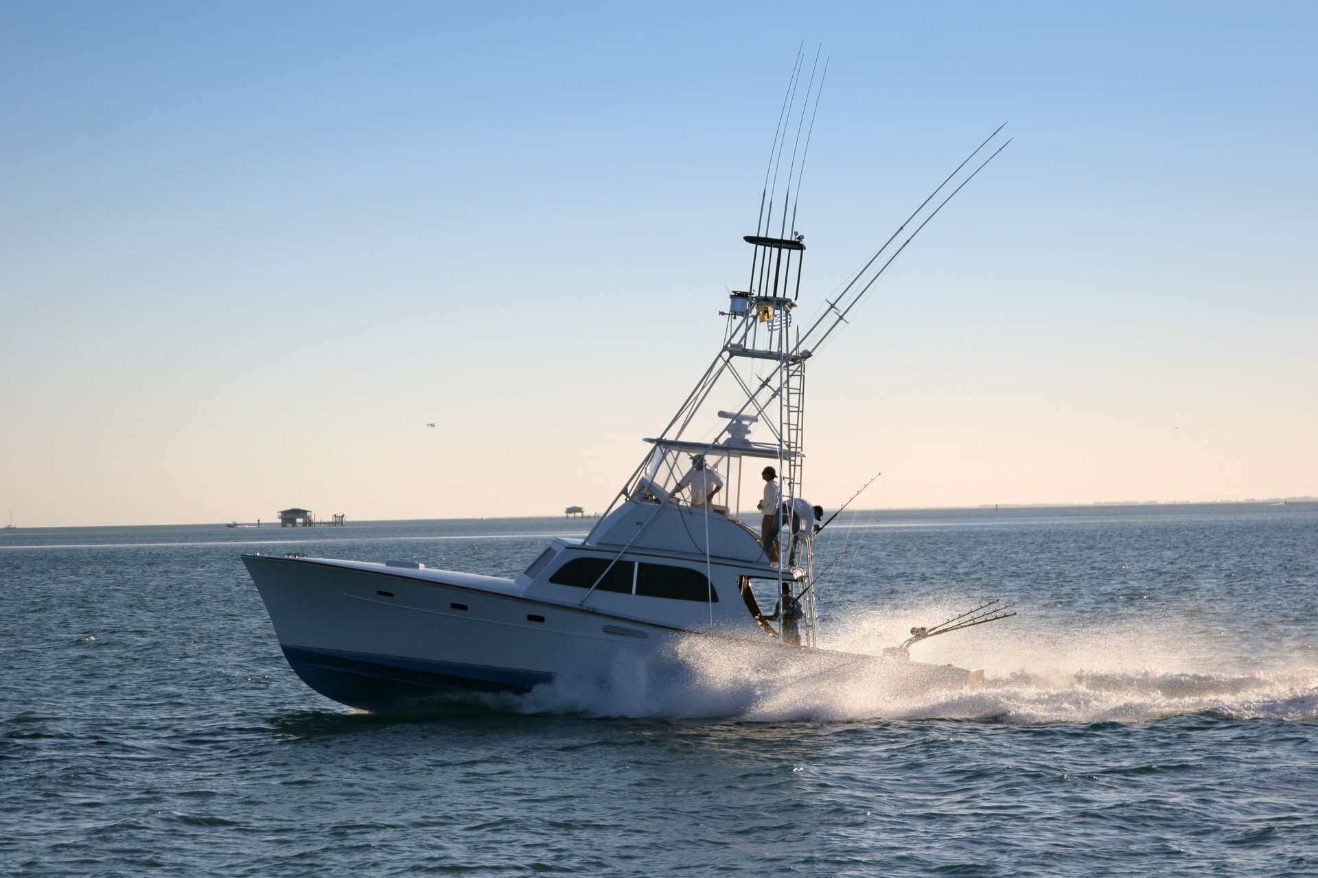 A yacht with a mast and rigging, moving through calm waters.
