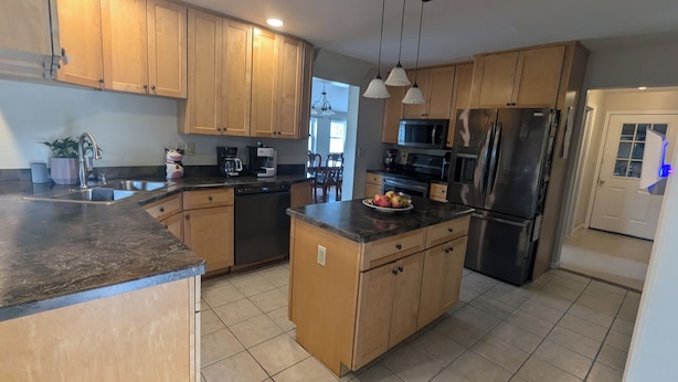 A kitchen with wooden cabinets, stainless steel appliances, and a granite countertop.