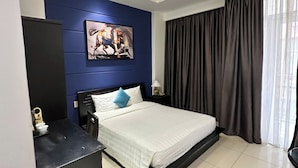A modern hotel room with a bed, a desk, a chair, a small refrigerator, a nightstand with a lamp, a painting on the wall, and a large window with curtains. - Nicecy Daily - Bui Vien Walking Street (Ho Chi Minh City)