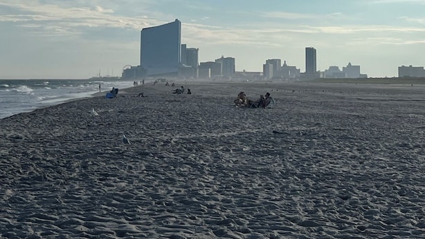 A beach with a city skyline in the background. - Brigantine Breeze 2-BR Coastal Retreat Steps to Beach (Brigantine)