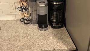 A kitchen with a coffee maker, a water dispenser, and a dishwasher. - Radiant and Cozy (Memphis)