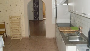 A kitchen with a wooden ladder, a sink, and cabinets. - Apartment 'Kelpin' with Private Terrace and Wi-Fi (Möllenbeck)