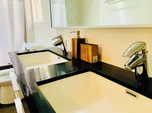 A bathroom with two sinks, a mirror, and a toilet. - Big Master Suite with private entry and shared yard in Culver City (Culver City)