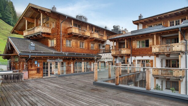 A wooden chalet with balconies, a wooden deck, and a mountain backdrop. - Apartment 'Panorama Chalets Am Pass Thurn' with Mountain View, Private Terrace and Wi-Fi (Mittersill)