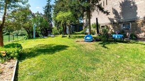 A grassy yard with a hammock, a table with chairs, and a building in the background. - Holiday Home 'Ferienhäuschen Kleine Auszeit' with Private Terrace, Private Garden and Wi-Fi (Seesbach)