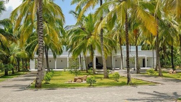 A resort with a central building surrounded by palm trees and a well-maintained lawn. - Lavendish Wild Wilpattu (Nochchiyagama)