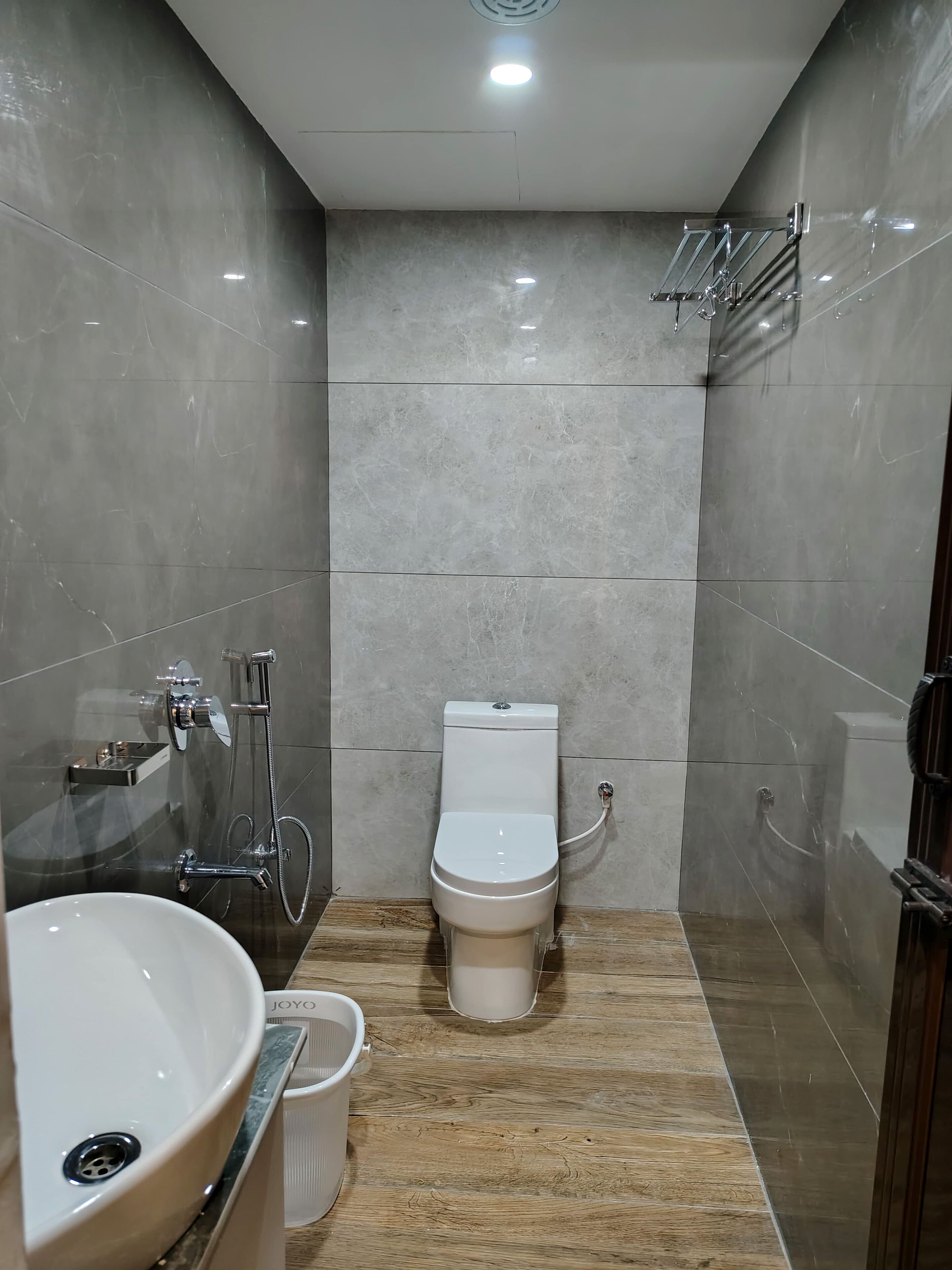 A modern bathroom with a toilet, bidet, and sink.