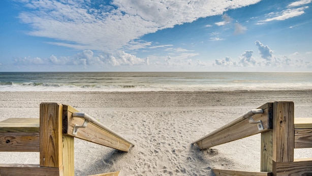 A wooden beach boardwalk leading to the ocean with a clear sky and clouds above. - Oceanfront Flagler Beach Unit w/ Water Views! (Flagler Beach)