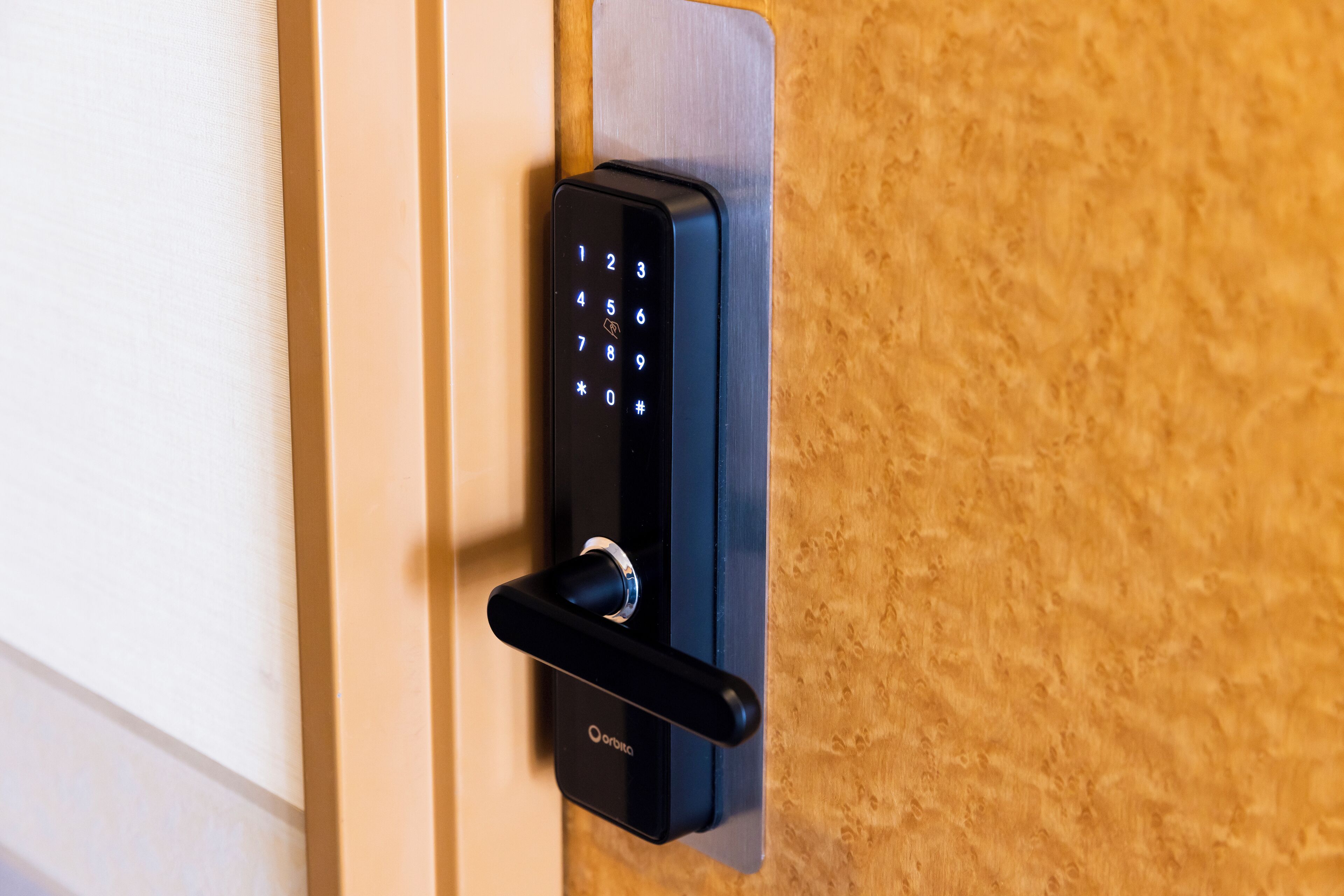 A modern door lock with a numeric keypad and a keyhole.