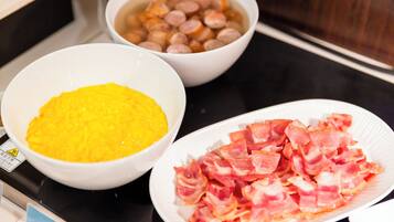 A kitchen counter with three bowls containing food items.