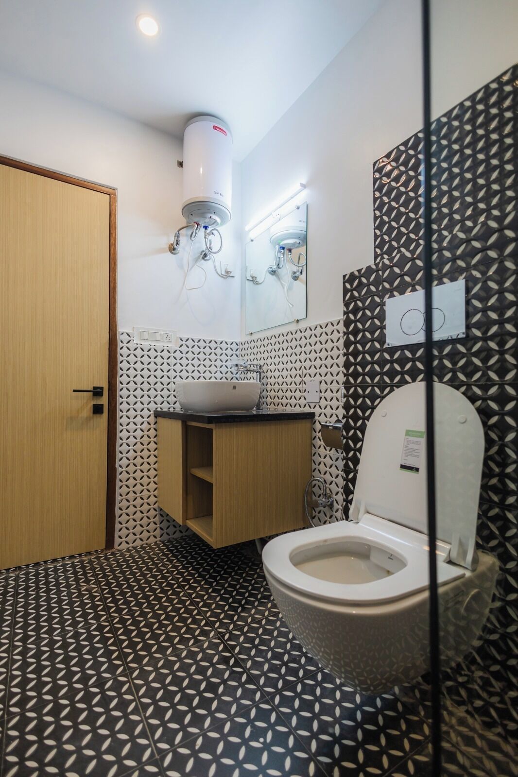 A modern bathroom with a toilet, sink, and shower.