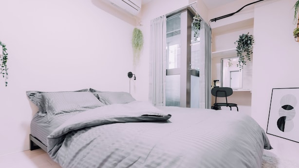 Una camera da letto moderna con un letto, una scrivania e una sedia.