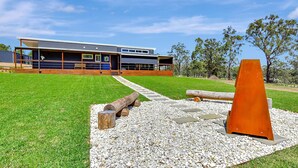 A modern building with a flat roof, large windows, and a covered outdoor area. - Two for Joy Estate. Sleeping 12, 2 Cottages (North Rothbury)