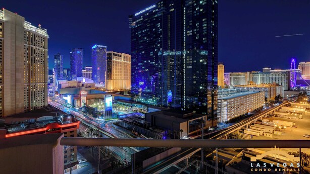 A nighttime cityscape with illuminated buildings and a busy street. - MGM Signature-Full Kitchen F1 Strip View 1BR (Las Vegas)