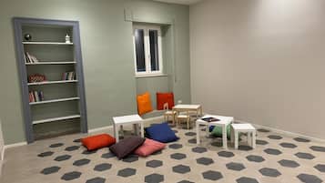 Cozy play area with a bookshelf, table, and chair, perfect for kids to read and play.