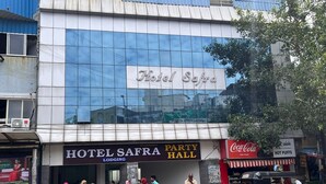 A hotel facade with a sign for "Hotel Safra" and a "Party Hall" below. - hotel safra (Chennai)
