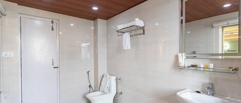 A modern bathroom with a toilet, sink, and mirror.