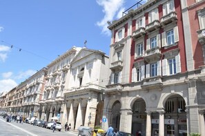 A row of historic buildings with classical architecture, including columns and arches. - Blanco Rooms (Cagliari)