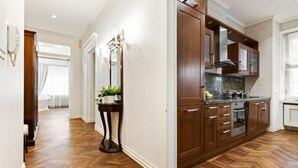 A modern kitchen with wooden cabinets, a granite countertop, and a built-in oven.