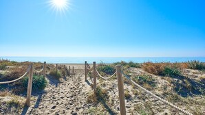 A sandy beach path with wooden posts and ropes, leading to the ocean. - Apartment 'Db01 Duna Beach Casa Zen' with Shared Pool, Wi-Fi and Air Conditioning (Torrox)
