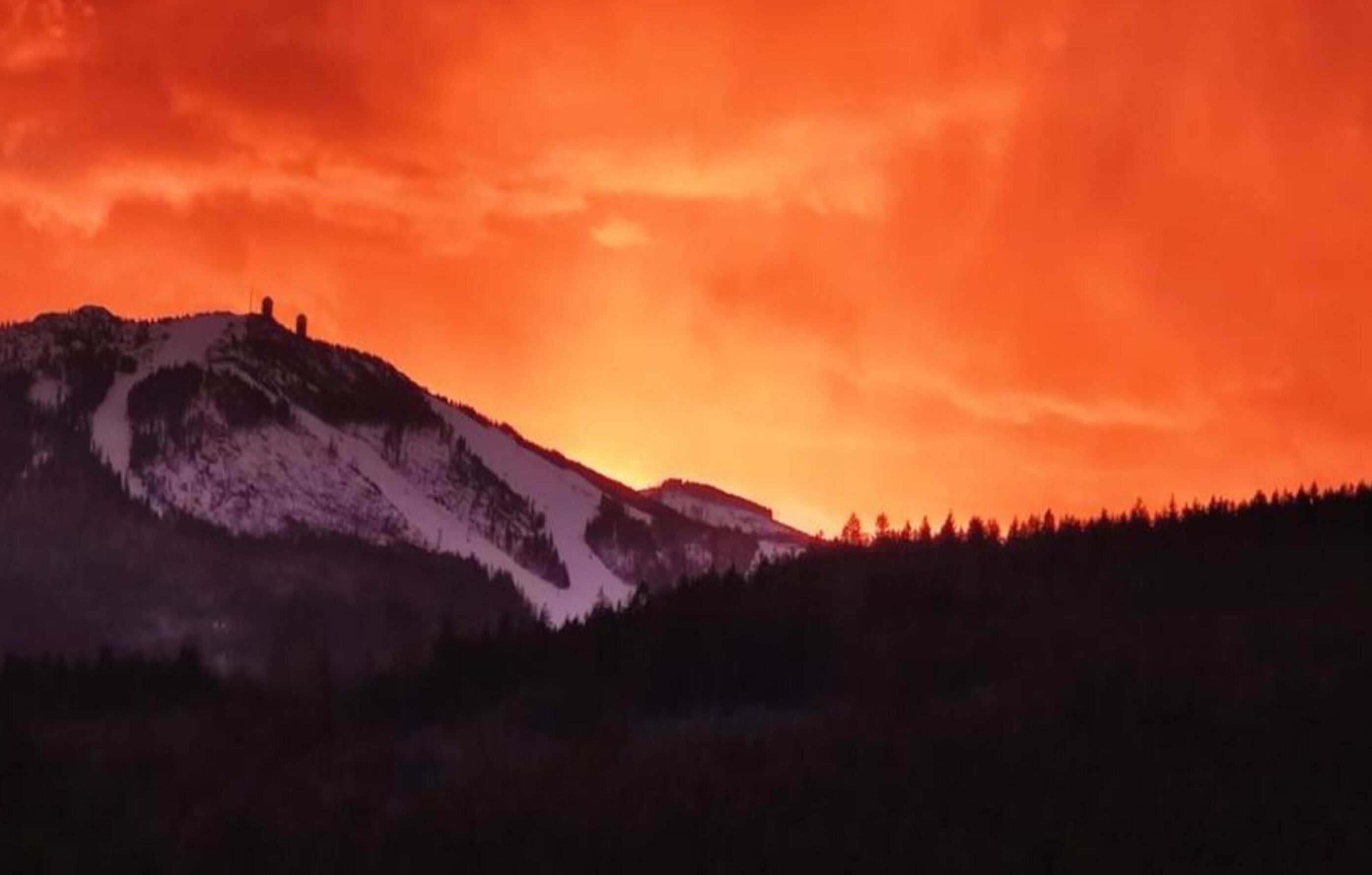 A mountain landscape with a sunset.