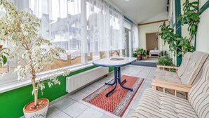A cozy living room with a sofa, a small table, and a potted plant. - Deluxe Holiday Home in Brilon-wald Near Ski Area (Brilon)