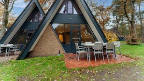 A modern, triangular-shaped building with a brick facade and large windows. - Test Property : Nice Bungalow 'muizenoortje' at Park Vosseven (Stramproy)