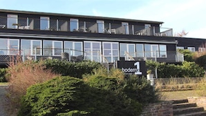 A modern building with multiple windows and a sign indicating 'boderne'. - 2 Person Holiday Home in Aakirkeby (Akirkeby)