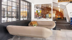 A modern interior with a seating area, large windows, and a visible restaurant named "BOWLING". - 14 Person Holiday Home on a Holiday Park in Blavand (Blavand)