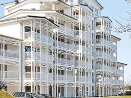 A multi-story building with balconies and a corner turret.
