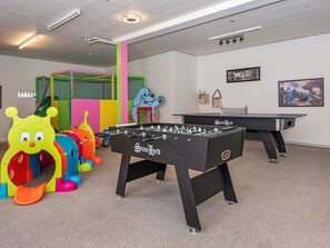 Relax and have fun in this recreational area with two foosball tables and a colorful play structure.