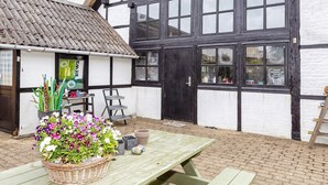 A traditional half-timbered building with a black door and multiple windows. - 6 Person Holiday Home on a Holiday Park in Hanstholm (Hanstholm)