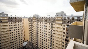 A high-rise residential building with multiple balconies and a central courtyard. - Kristal Absheron (Baku)