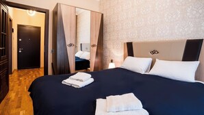 A hotel room with a large bed, a wardrobe, and a mirror. - Kristal Absheron (Baku)