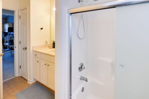 A bathroom with a bathtub, a shower, and a vanity with a sink and mirror. - 4 Mi to Beach: Lewes Townhome w/ Ping-pong Table (Rehoboth Beach)