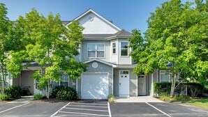 A two-story residential building with a garage, a driveway, and a parking lot. - 4 Mi to Beach: Lewes Townhome w/ Ping-pong Table (Rehoboth Beach)