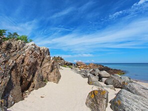 A rocky coastal path leading to the sea with a clear sky. - 2 Person Holiday Home in Allinge (Allinge)