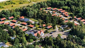 An aerial view of a residential area with houses, a beach, and a parking lot. - 6 Person Holiday Home on a Holiday Park in Vaeggerlose (Vaeggerlose)