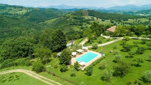 An aerial view of a property with a swimming pool, surrounded by lush greenery and hills. - Farmhouse in Hilly Area in Gubbio With Pool (Gubbio)