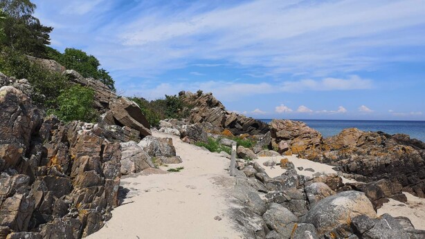 A rocky coastal path leading to the sea with a clear sky. - 4 Person Holiday Home in Allinge (Allinge)
